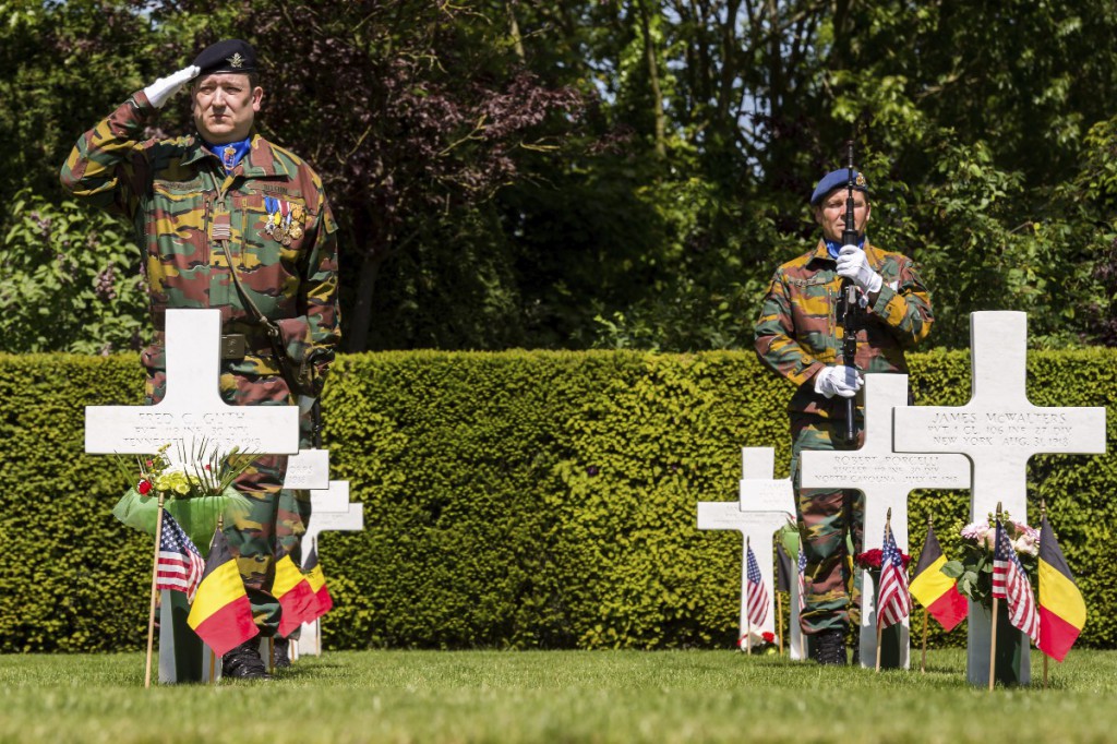 Belgian soldiers salute during a Memorial Day Ceremony at the Flanders Fields American Cemetery in Waregem, Belgium, on Sunday May 24, 2015. (AP Photo/Geert Vanden Wijngaert)
